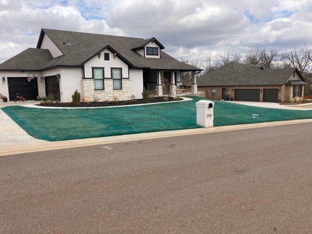 House with lawn sprayed blue for weed control