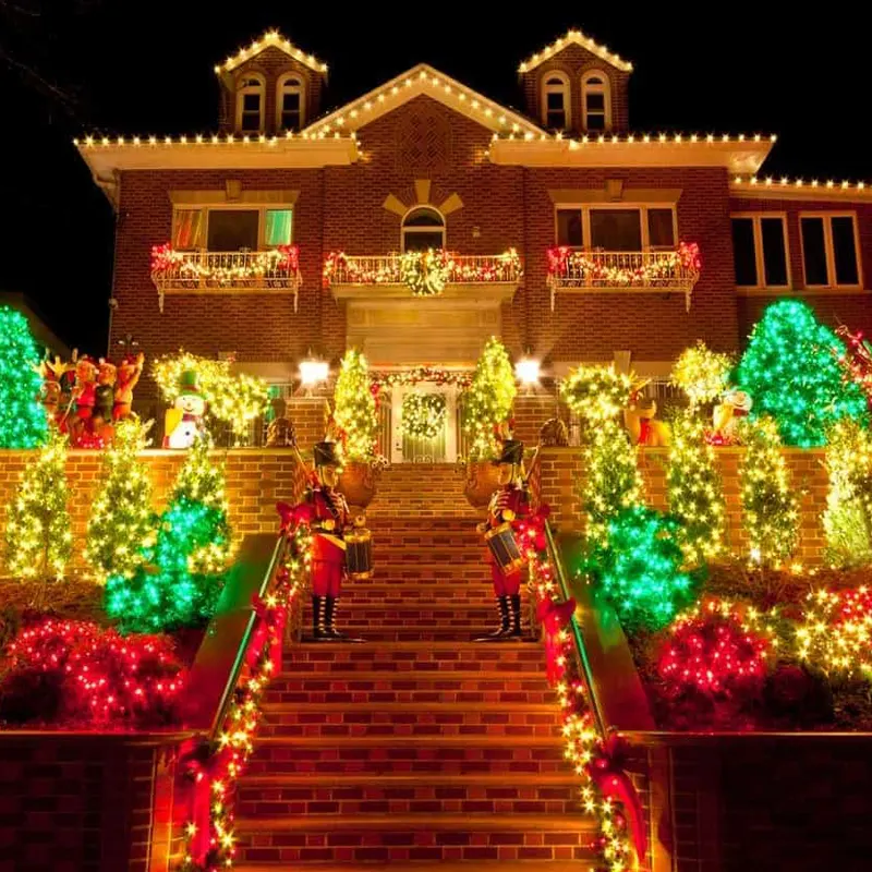 Brick house with colorful Christmas light installation Brick house with colorful Christmas light installation