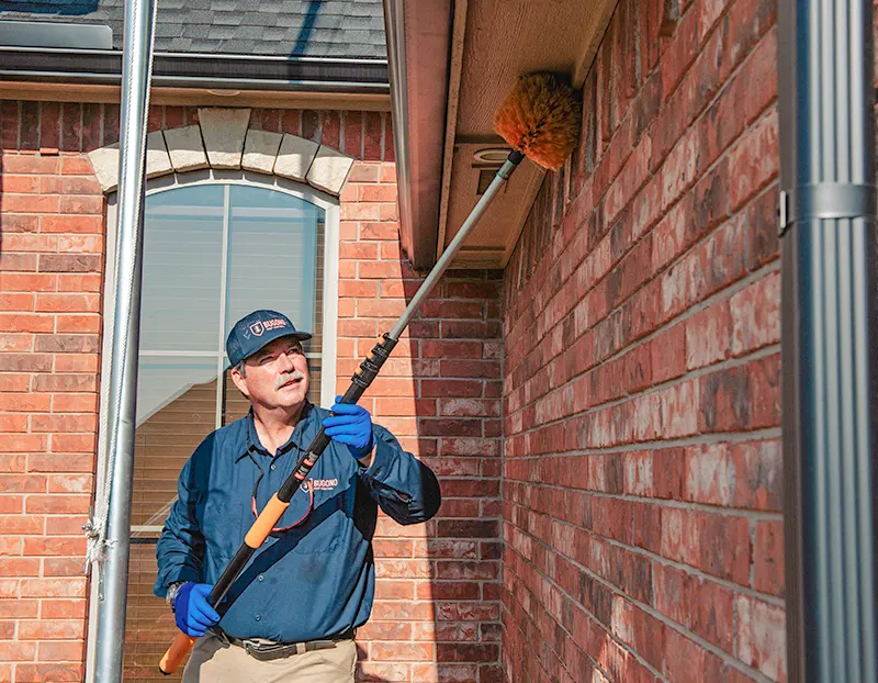 bugono-tech-pest-control-spraying-home Bugono tech pest control treatment outside home in Oklahoma City