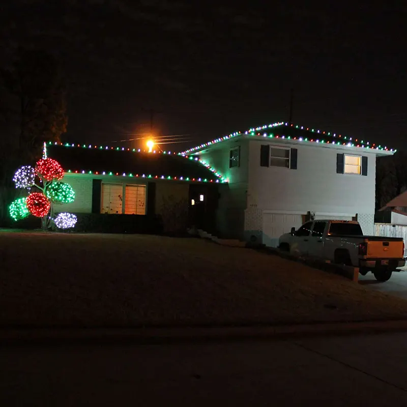 Roof of home trimmed with colored Christmas lights Roof of home trimmed with colored Christmas lights