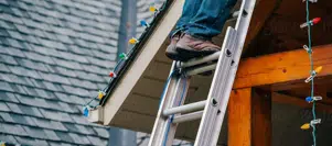 Installing Christmas lights on roof with ladder Installing Christmas lights on roof with ladder