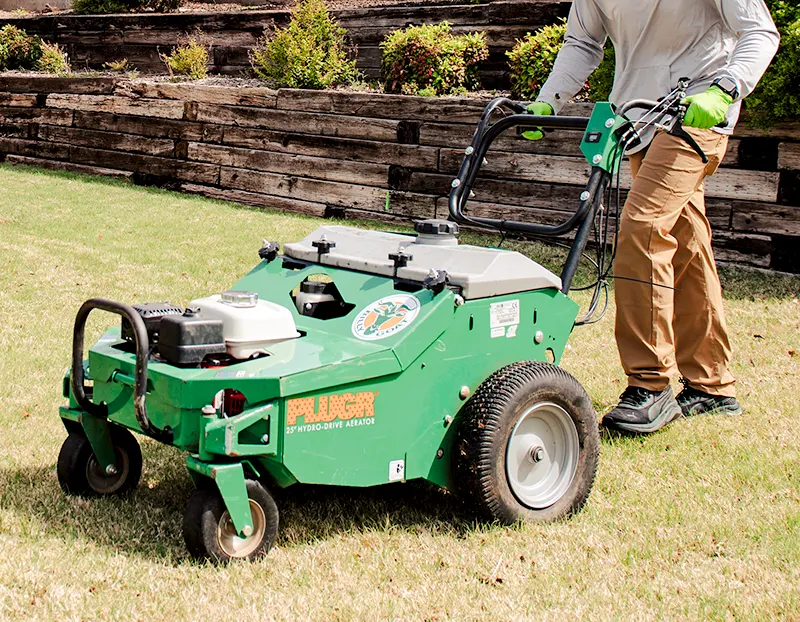 Willis Lawn Services tech using Plugr aerator