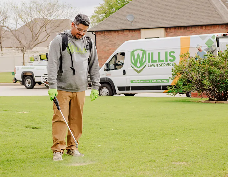 Willis Lawn Services applying Root Booster grass treatment to yard in Oklahoma City